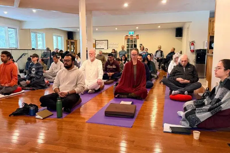Large group of retreat participants practicing mindfulness meditation at Mahamevnawa Buddha Meditation Centre Winnipeg